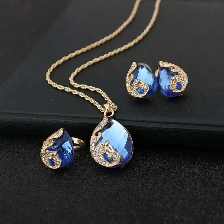Set de collar y pendientes de cristal azul con acabado oro