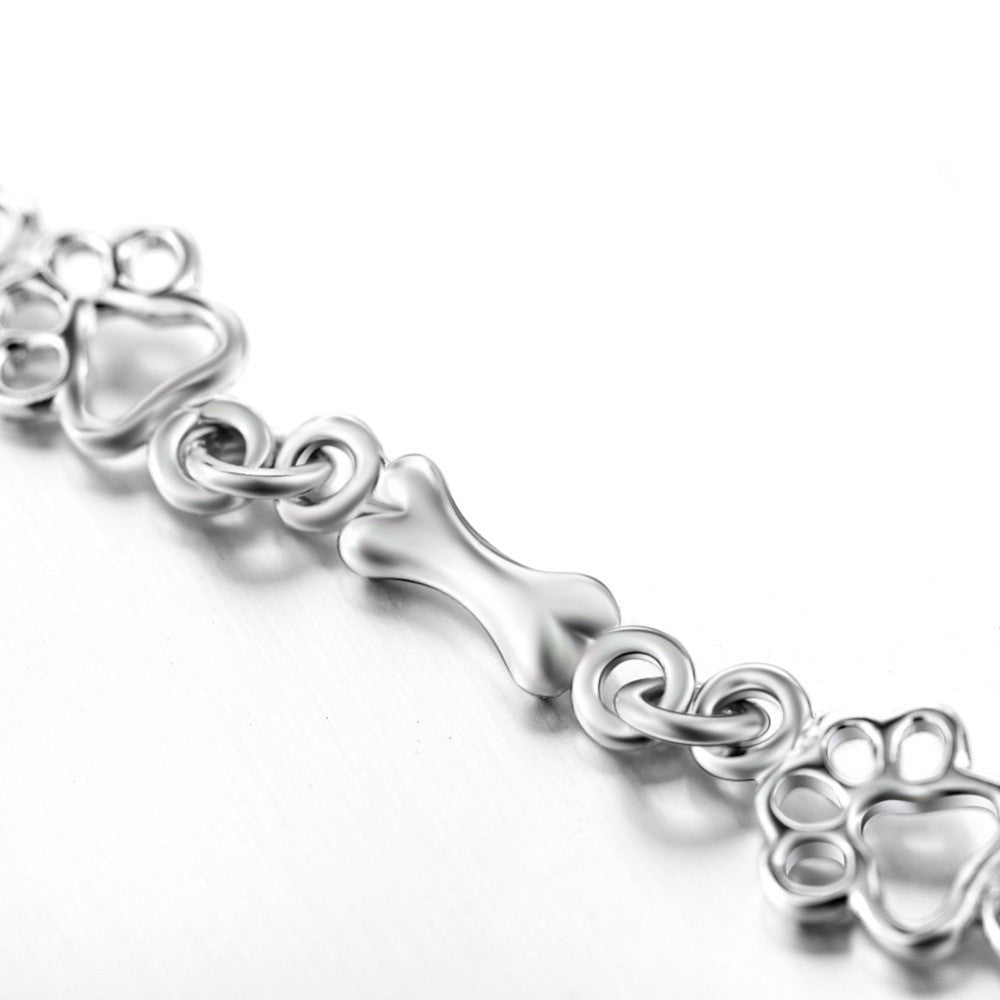 Pulsera edición limitada con colgantes de plata maciza en forma de pata de perro y hueso
