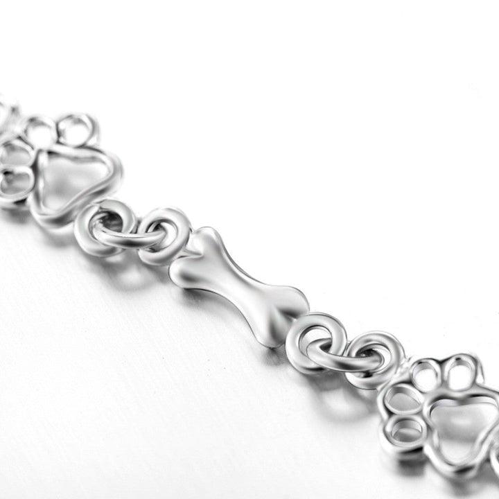 Pulsera edición limitada con colgantes de plata maciza en forma de pata de perro y hueso