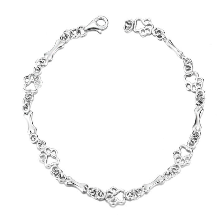 Pulsera edición limitada con colgantes de plata maciza en forma de pata de perro y hueso