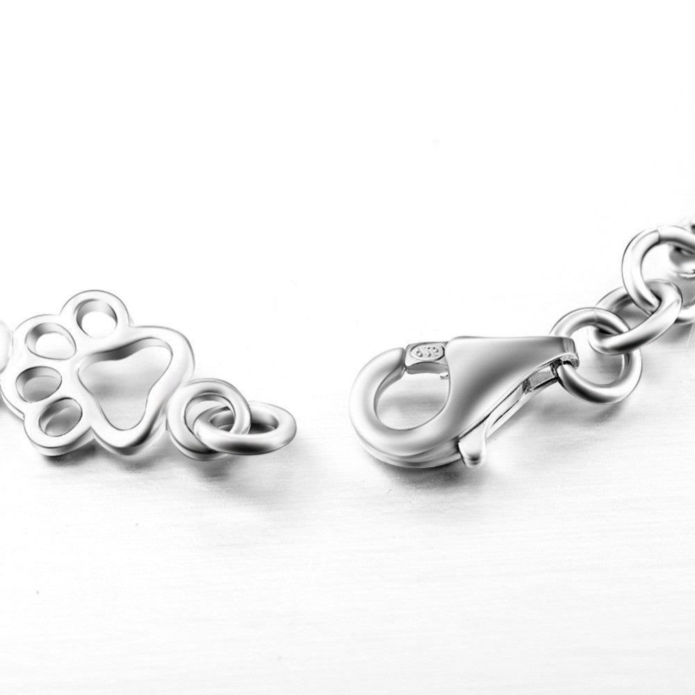 Pulsera edición limitada con colgantes de plata maciza en forma de pata de perro y hueso