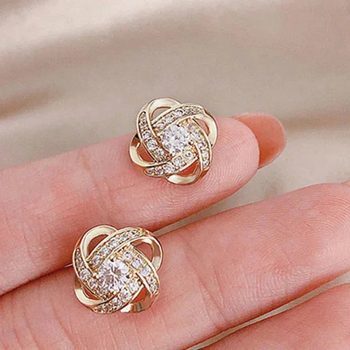 Pendientes en espiral floral cruzada