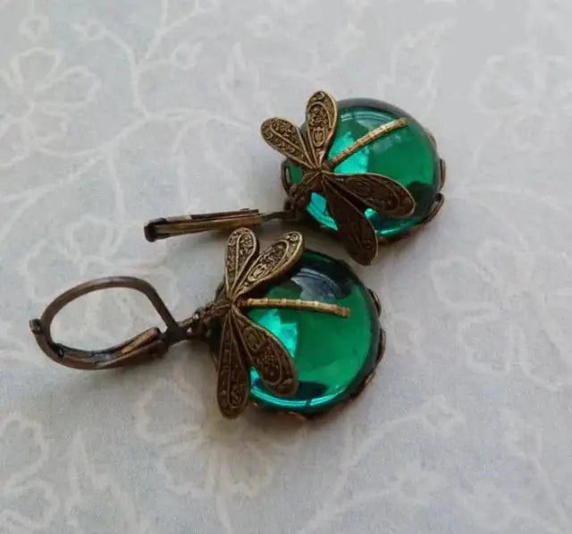 Pendientes vintage esféricos dorados con libélula