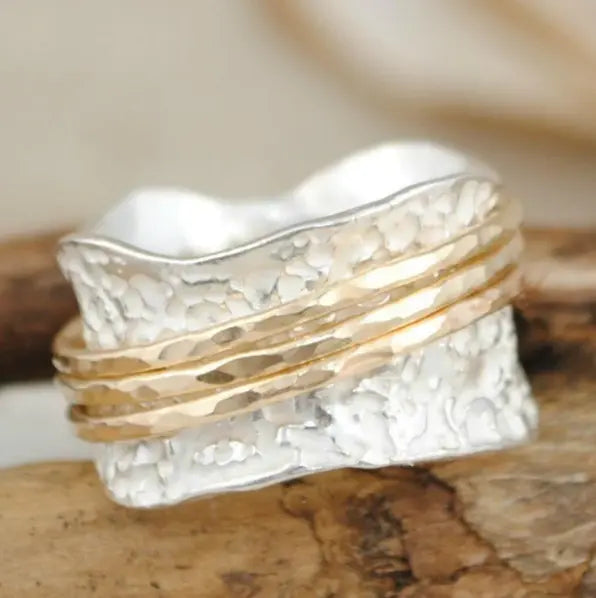 Elegante anillo vintage giratorio de oro y plata